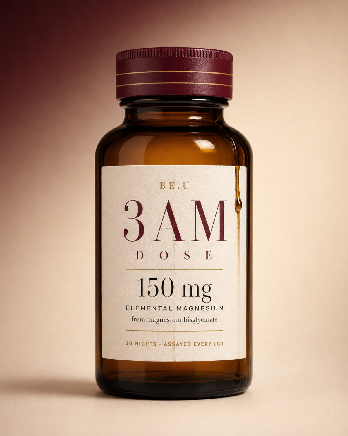 An amber glass supplement bottle with a cream label reading 'BE.U 3AM DOSE 150 mg' and a dark burgundy cap, centered on a warm beige background.